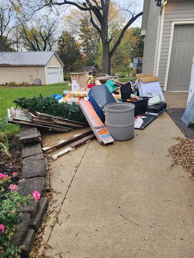 Dumpster being loaded with debris for 12 Yard Dumpster Rental in Hebron